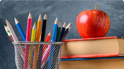 a group of pens and pencils in a basket