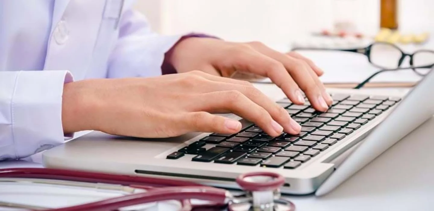 person writing on a keyboard