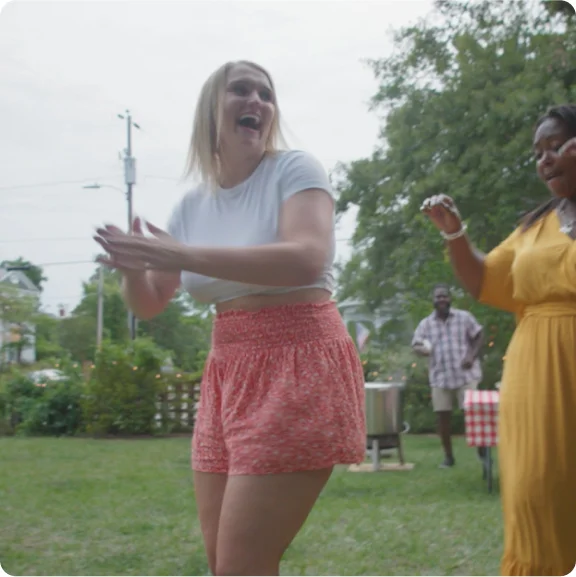 A group of people laughing and dancing.
